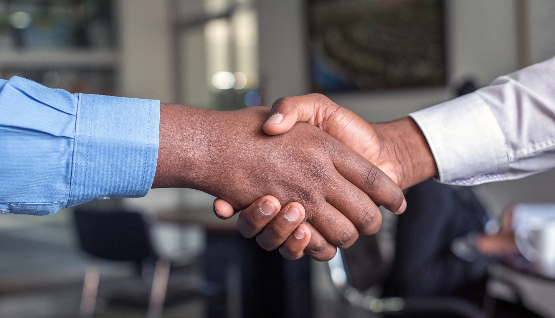 job applicant and recruiter shaking hands