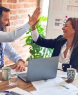 hiring agency man and woman high fiving